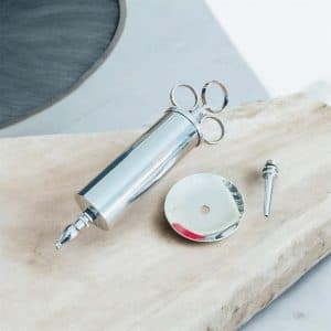 Metal ear syringe with two nozzles